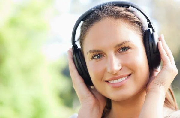 Close up van een vrouw luisteren naar muziek in het park — Stockfoto