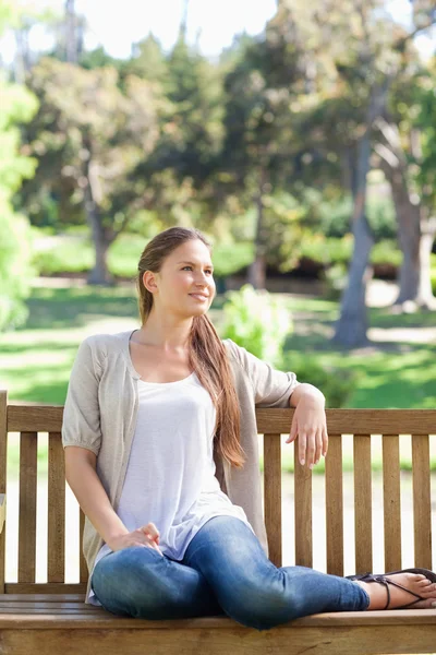 Donna rilassante su una panchina del parco — Foto Stock