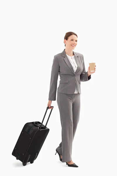 Businesswoman with coffee and suitcase — Stock Photo, Image