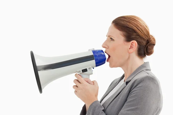 Businesswoman talking into megaphone — Stock Photo, Image