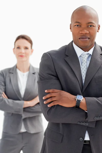 Businesswoman stands behind businessman — Stock Photo, Image