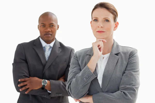 Businesswoman resting head on hand in front of businessman — Stock Photo, Image
