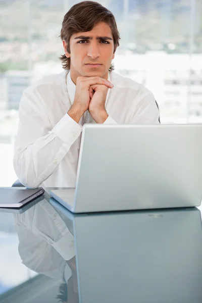 Serious young businessman with a laptop — Stock Photo, Image