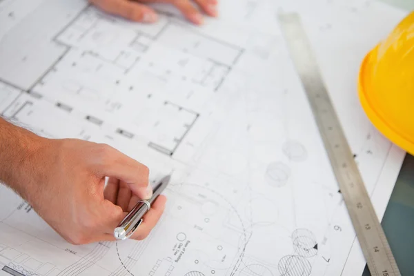 Close up of blueprints with a person making adjustments — Stock Photo, Image