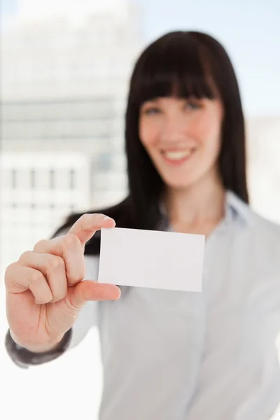 Focus on the business card with a woman holding it — Stock Photo, Image