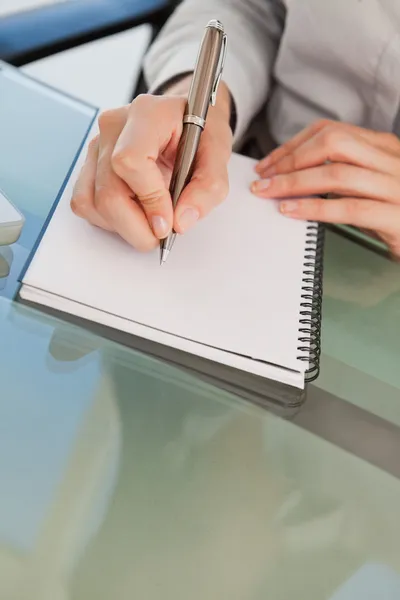 Close up of a woman jotting down some notes — Stock Photo, Image