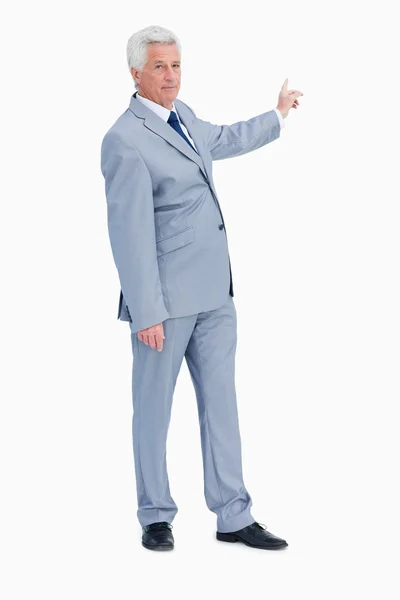 Portrait of a businessman pointing in his back — Stock Photo, Image