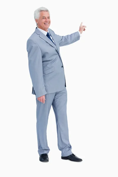 Portrait of a businessman pointing behind him — Stock Photo, Image