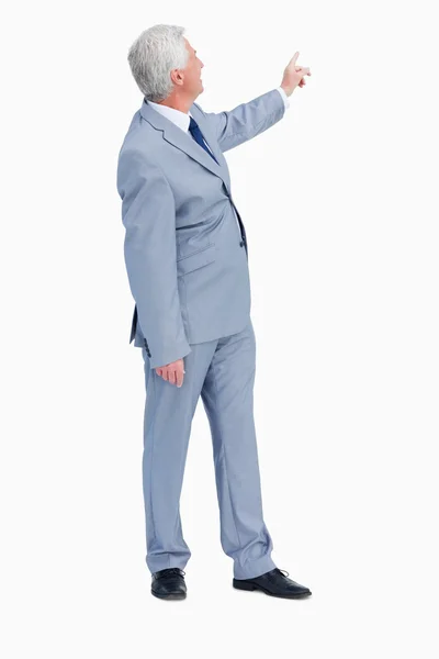 Businessman pointing behind him — Stock Photo, Image