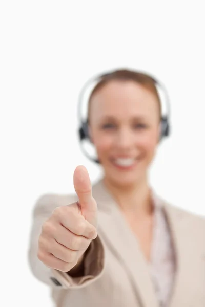 Thumbs up of a businesswoman wearing a headset — Stock Photo, Image