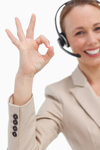 Approbation of a businesswoman with a headset — Stock Photo, Image