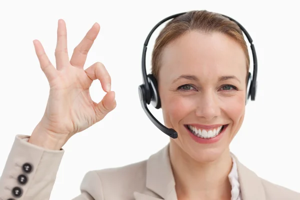 Woman in a suit with a headset approving — Stock Photo, Image