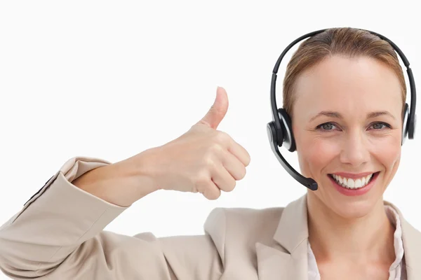 Woman in a suit with a headset the thumb-up — Stock Photo, Image