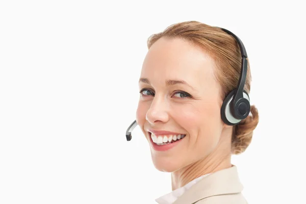 Portrait of a smiling woman in a suit with headset — Stock Photo, Image