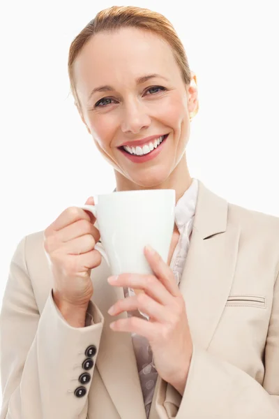 Portrait of a woman in a suit holding a mug — Stock Photo, Image