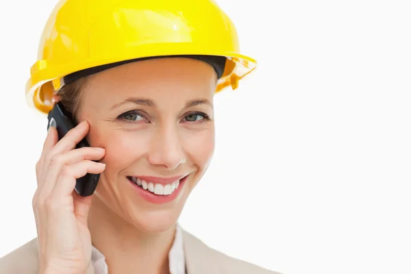 Portrait of a woman wearing safety helmet on the phone — Stock Photo, Image