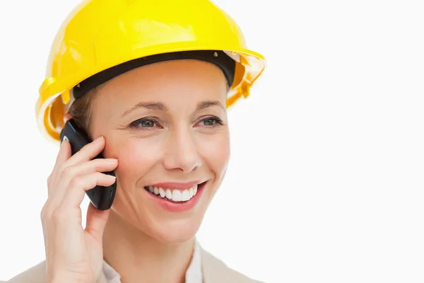 Woman wearing safety helmet on the phone — Stock Photo, Image