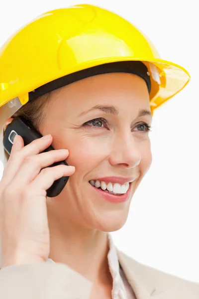 Close-up of a woman wearing safety helmet on the phone — Stock Photo, Image