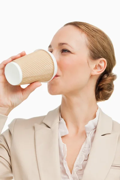 Businesswoman in a suit drinking a takeaway coffee — Stock Photo, Image