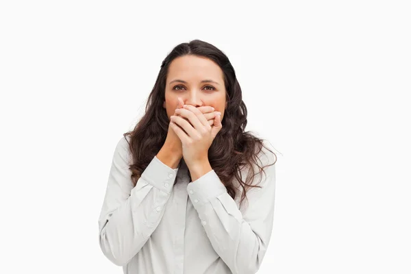 Portrait of a brunette with her hands on the mouth — Stock Photo, Image