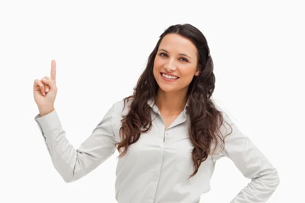 Portrait of a brunette pointing up — Stock Photo, Image