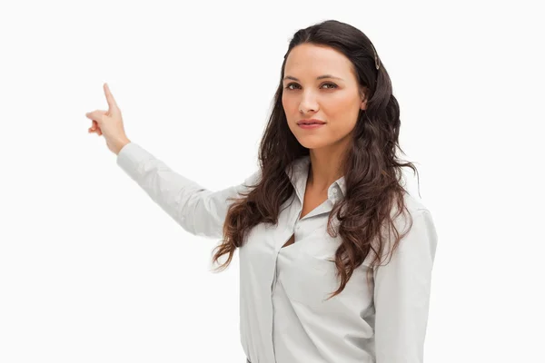 Portrait of a brunette pointing in her back — Stock Photo, Image