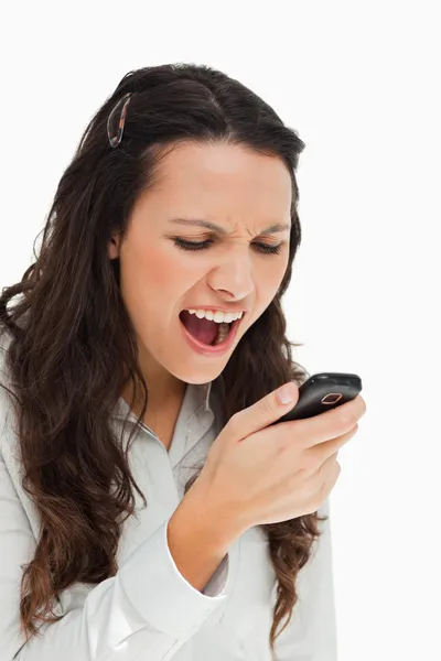 Brunetka grymasy czytając jej SMS — Zdjęcie stockowe