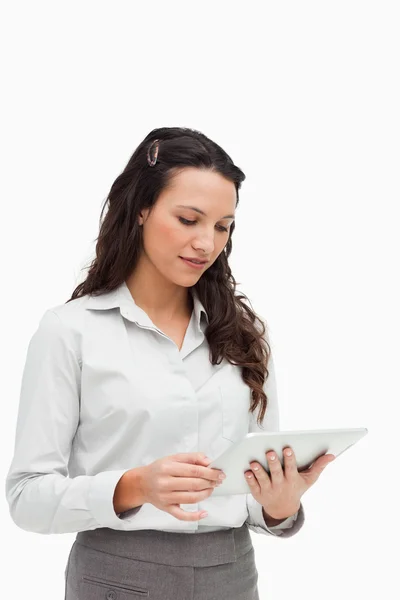 Brunette standing while using a touchpad — Stock Photo, Image
