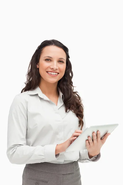 Portrait of a brunette standing while using a touchpad — Stock Photo, Image