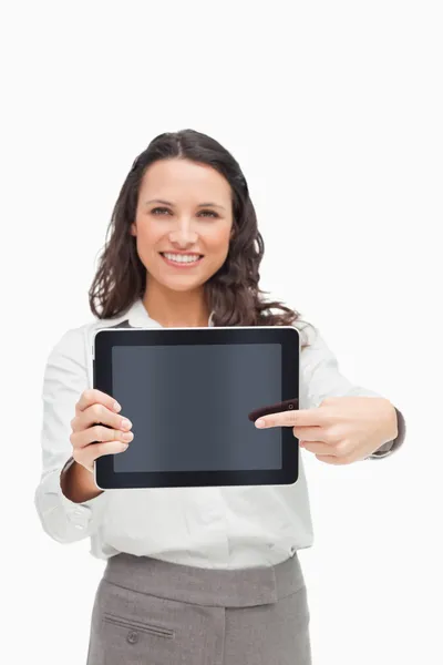 Portrait of a brunette showing and pointing a touchpad screen — Stock Photo, Image