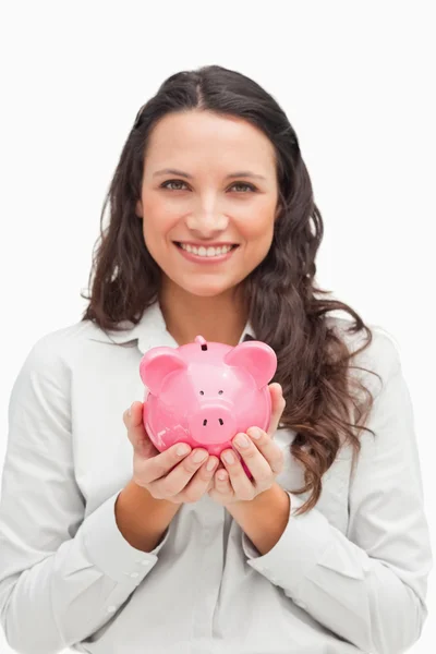 Brunette holding a piggy bank — Stock Photo, Image