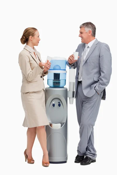 stock image Business laughing next to the water dispenser