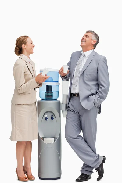 stock image laughing next to the water dispenser