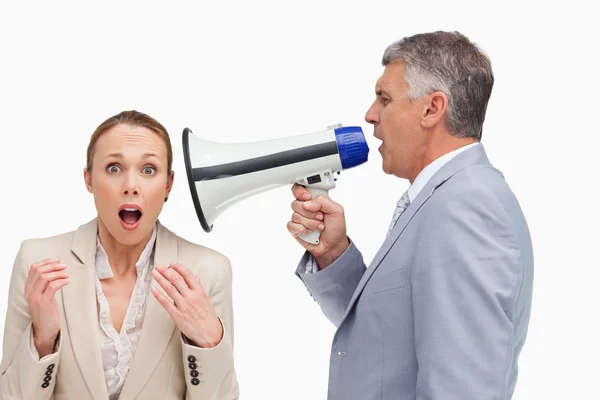Businessman using a megaphone after his colleague — Stock Photo, Image
