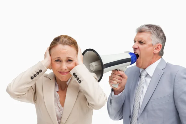 Businessman yelling with a megaphone after his colleague — Stock Photo, Image