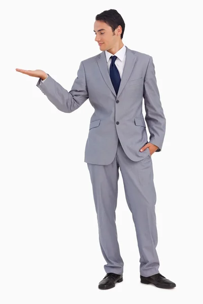 Good-looking man presenting with the hand — Stock Photo, Image
