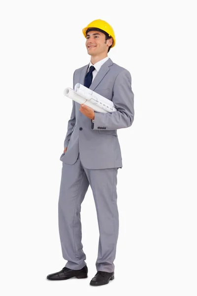 Smiling man in a suit with safety helmet and plans — Stock Photo, Image