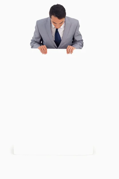 Good-looking man holding a big poster — Stock Photo, Image