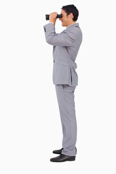 Profile of a businessman using binoculars — Stock Photo, Image