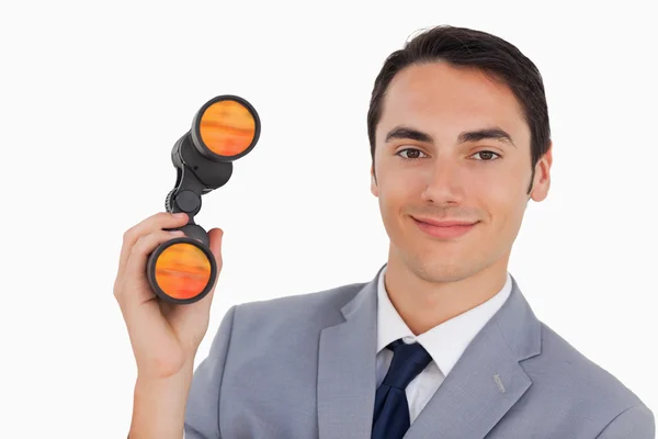 Close-up of a smiling businessman with binoculars — Stock Photo, Image