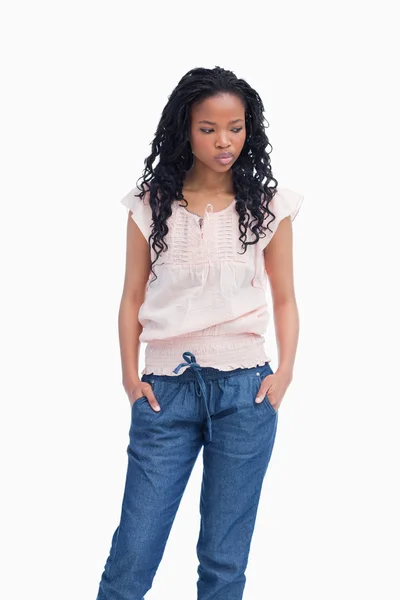 A young woman is thinking and standing with her hands in her poc — Stock Photo, Image