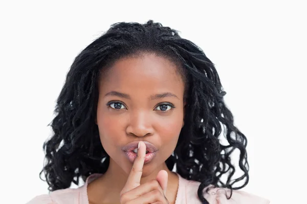 A young woman with her finger up to her lips — Stock Photo, Image