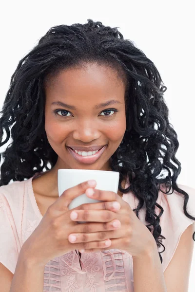 A woman is holding cup of coffee with both hands — Stock Photo, Image