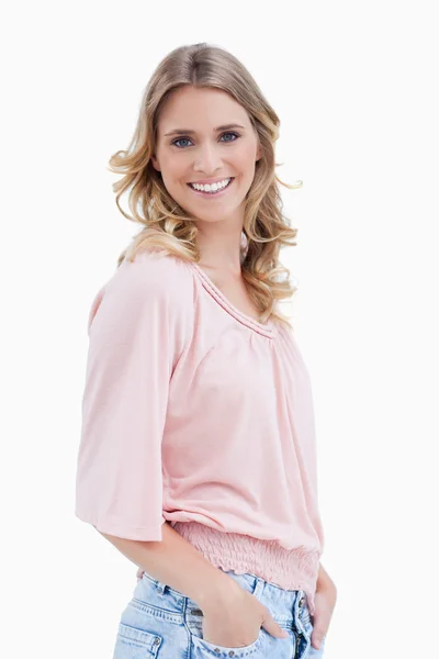 Side view shot of a woman with her hands in her pocket smiling a — Stock Photo, Image
