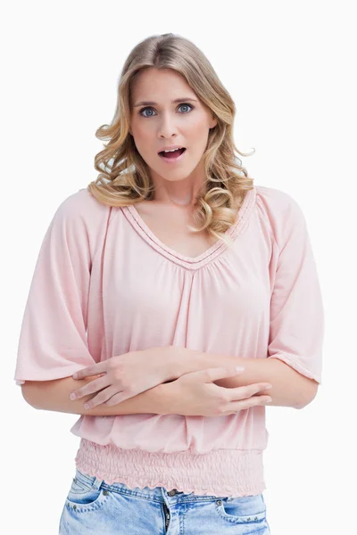 Woman with a shocked expression on her face has her arms crossed — Stock Photo, Image
