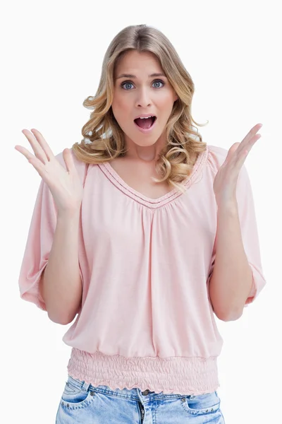 A surprised woman has her arms held up in front of her — Stock Photo, Image