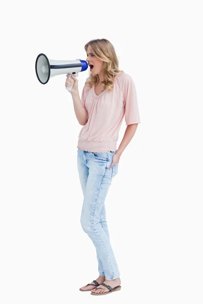 Young woman shouting with a megaphone — Stock Photo, Image