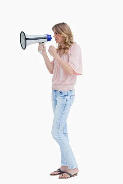Serious young woman holding a megaphone — Stock Photo, Image