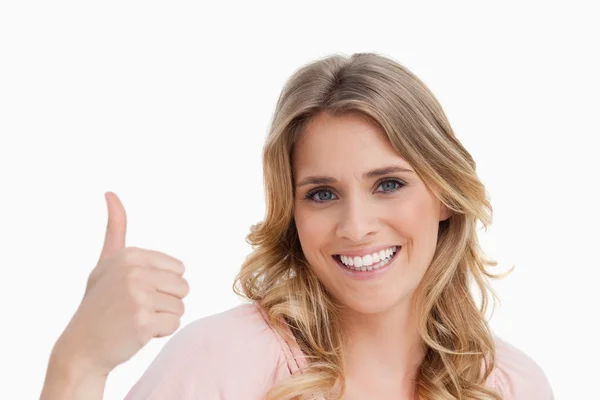 Young smiling woman placing her thumbs up — Stock Photo, Image