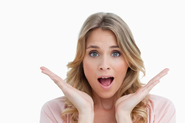 Surprised young woman raising her hands — Stock Photo, Image